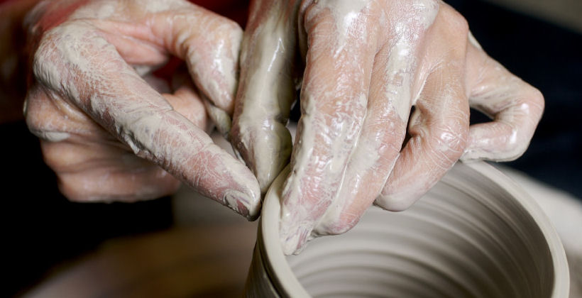 Potter shaping a clay vessel